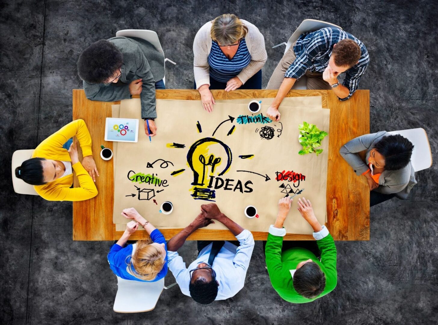 Eight people sitting around a table discussing ideas